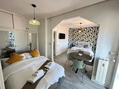 a bedroom with a large bed and a table at Attico al Settimo Piano in Rome
