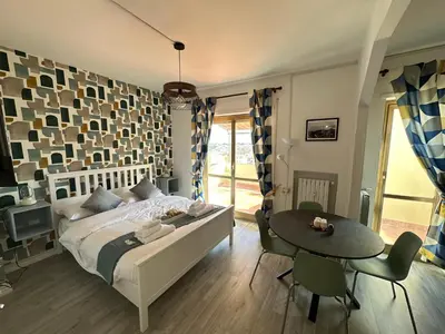 a bedroom with a bed and a table and chairs at Attico al Settimo Piano in Rome