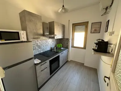 a kitchen with a refrigerator and a sink at Attico al Settimo Piano in Rome