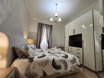 a bedroom with a large bed and a television at Beatrice's House Spa Bath Privata e Parcheggio Gratuito a Roma in Rome