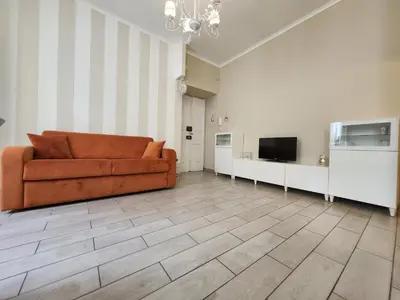 a living room with a couch and a television at Beatrice's House Spa Bath Privata e Parcheggio Gratuito a Roma in Rome