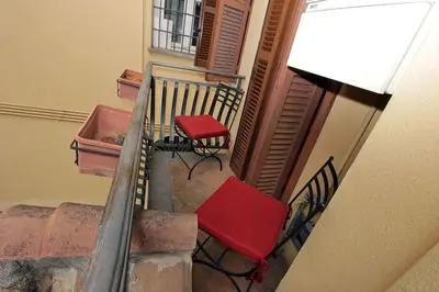 a stairway with two red chairs and a window at Bollo Studio in Rome