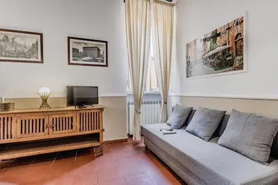 a living room with a couch and a tv at Sweet home Trastevere- Roma in Rome