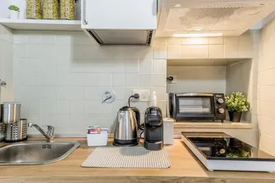 a kitchen counter with a sink and a microwave at Sweet home Trastevere- Roma in Rome