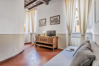 a living room with a couch and a tv at Sweet home Trastevere- Roma in Rome
