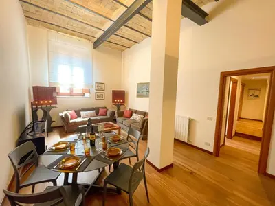 a living room with a table and a couch at Velabro Luxury Loft in Rome