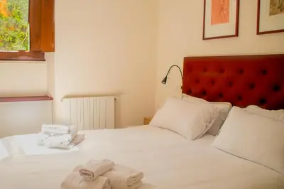 a bedroom with a white bed with towels on it at Velabro Luxury Loft in Rome