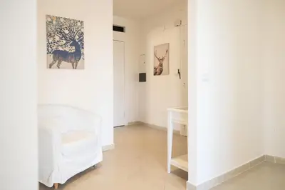 a room with white walls and paintings on the wall at Roma per te in Rome