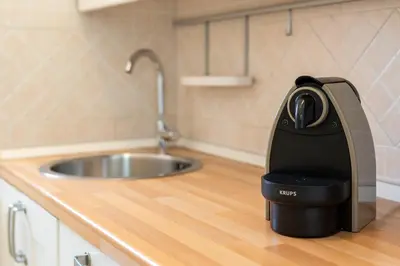 a coffee maker sitting on a counter next to a sink at Roma per te in Rome