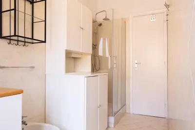 a kitchen with a white refrigerator and a door at Roma per te in Rome