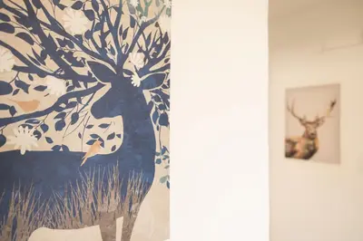 a painting of a deer in a tree on a wall at Roma per te in Rome