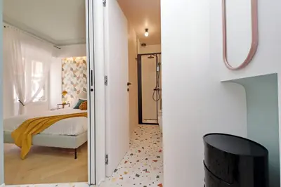 a bedroom with a bed and a sliding glass door at YCH-Colorful and classy apartment near Fori Imperiali in Rome