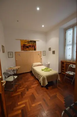 a bedroom with a bed and a table and chairs at Casa Vacanze Zio Gionni in Rome