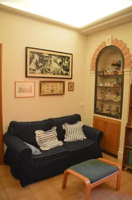 a living room with a black couch and a table at Casa Vacanze Zio Gionni in Rome
