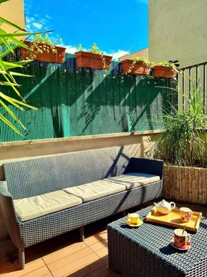 a bench and a table on a balcony at Vatican Terrace Apartment in Rome