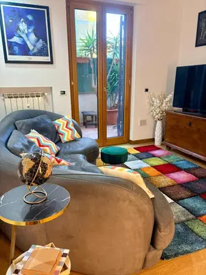 a living room with a couch and a tv at Vatican Terrace Apartment in Rome