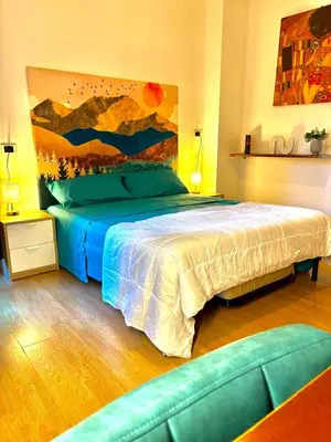 a bedroom with a bed and a painting on the wall at Vatican Terrace Apartment in Rome
