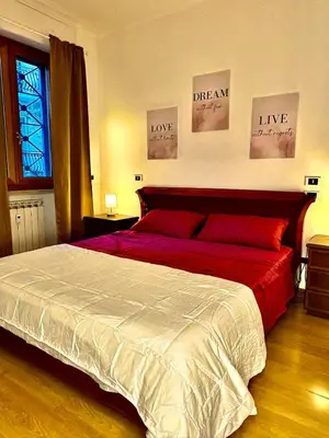a bedroom with a large bed with two posters on the wall at Vatican Terrace Apartment in Rome