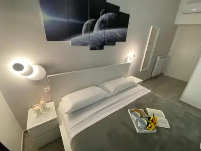 a white room with a bed and a table at ROMA Guesthouse Affittacamere centro citta' SOFTROOMS-Metro' a 1 metro in Rome