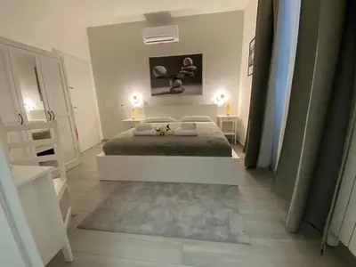 a white bedroom with a bed and a mirror at ROMA Guesthouse Affittacamere centro citta' SOFTROOMS-Metro' a 1 metro in Rome