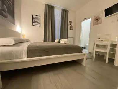 a bedroom with a large bed and a window at ROMA Guesthouse Affittacamere centro citta' SOFTROOMS-Metro' a 1 metro in Rome