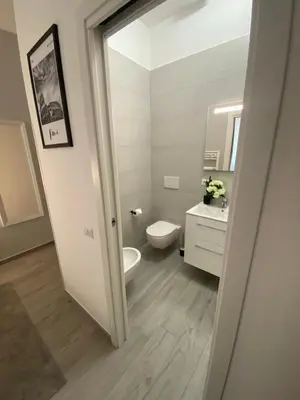a white bathroom with a toilet and a sink at ROMA Guesthouse Affittacamere centro citta' SOFTROOMS-Metro' a 1 metro in Rome
