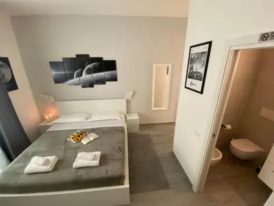 a small bedroom with a bed and a bathroom at ROMA Guesthouse Affittacamere centro citta' SOFTROOMS-Metro' a 1 metro in Rome