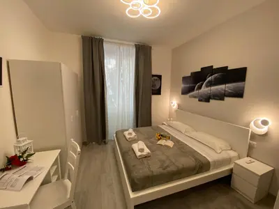 a bedroom with a bed and a table and a desk at ROMA Guesthouse Affittacamere centro citta' SOFTROOMS-Metro' a 1 metro in Rome