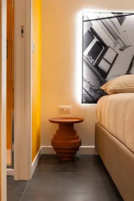 a small table next to a bed in a room at Embassy Suites Roma in Rome