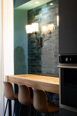 a table with chairs and a light on a brick wall at Embassy Suites Roma in Rome