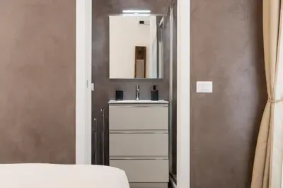 a bathroom with a sink and a mirror at Embassy Suites Roma in Rome