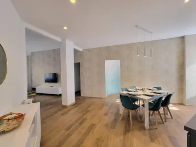 a living room with a couch and chairs and a tv at RomeBestHome Beccaria - Piazza del Popolo in Rome