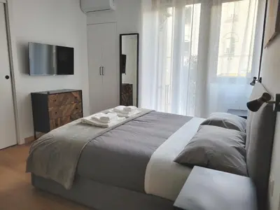 a bedroom with a large bed and a television at RomeBestHome Beccaria - Piazza del Popolo in Rome