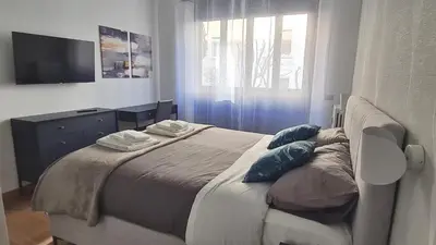 a bedroom with a large bed with blue pillows at RomeBestHome Beccaria - Piazza del Popolo in Rome