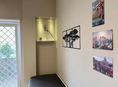 a corner of a room with pictures on the wall at Vatican - Angolo di Roma in Rome