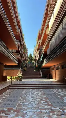 an empty courtyard of a large building with stairs at Vatican - Angolo di Roma in Rome