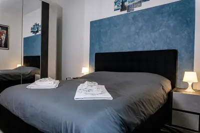 a bedroom with a bed with towels on it at Pamphili Rooms in Rome