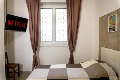 a bedroom with a bed and a window at Pamphili Rooms in Rome