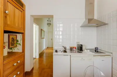 a kitchen with a sink and a counter top at Charming apartment in a 1910s building 2 min walk from the Colosseum in Rome