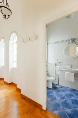 a bathroom with a toilet and a sink at Charming apartment in a 1910s building 2 min walk from the Colosseum in Rome