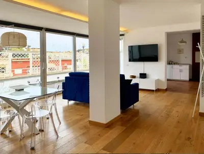 a living room with a blue couch and a table at DaliTourism - Vatican Apartment 77 in Rome