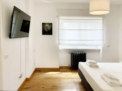 a bedroom with two beds and a television on the wall at DaliTourism - Vatican Apartment 77 in Rome