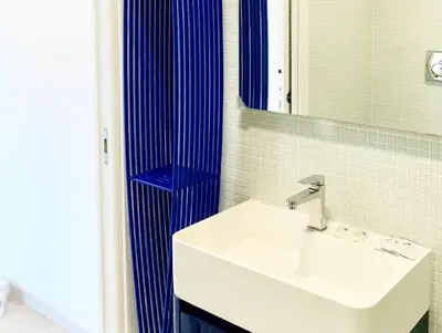 a bathroom with a sink and a blue shower at DaliTourism - Vatican Apartment 77 in Rome