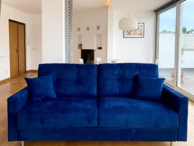 a blue couch in the middle of a living room at DaliTourism - Vatican Apartment 77 in Rome