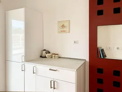 a kitchen with white cabinets and a refrigerator at DaliTourism - Vatican Apartment 77 in Rome