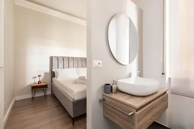 a bathroom with a sink and a mirror at Vatican Clodio Suites in Rome