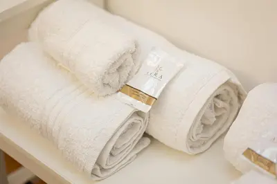 a pile of towels sitting on a shelf at Khris Home Apartments - Trastevere Parini in Rome