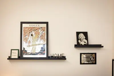 two shelves on a wall with pictures on it at Khris Home Apartments - Trastevere Parini in Rome