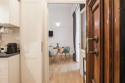 a hallway with a door leading to a kitchen with a table at Scipioni Vatican Studio distante 10 minuti a piedi dal Vaticano in Rome