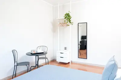 a bedroom with a table and chairs and a mirror at La Lanterna Di San Pietro in Rome